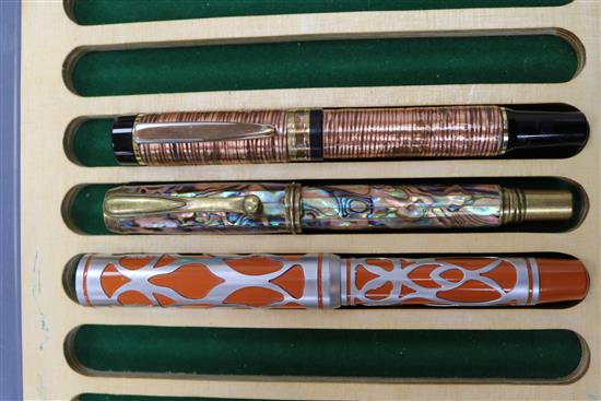 Three ornate fountain pens, cased